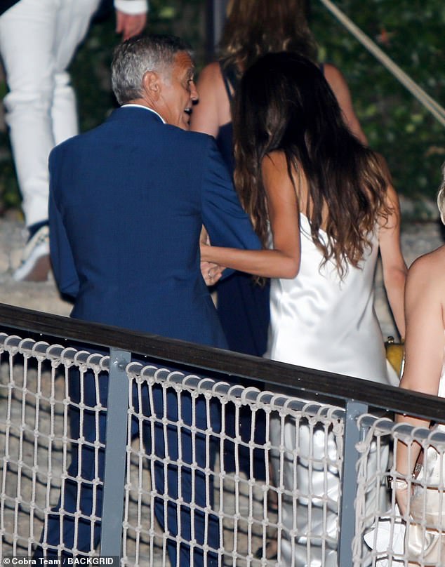 Amal, 46, looked stunning in a white silk dress and flats for the occasion, while George, 63, opted for a tailored blue suit and a white shirt that he left partially open