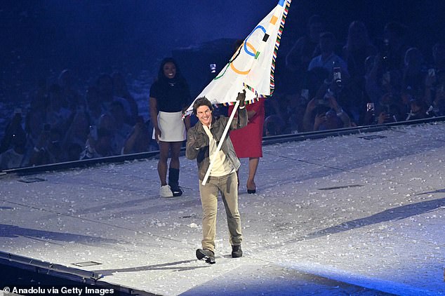 Cruise waves the Olympic flag during the closing ceremony of the Paris 2024 Olympic Games at the Stade de France on August 11, 2024 in Paris