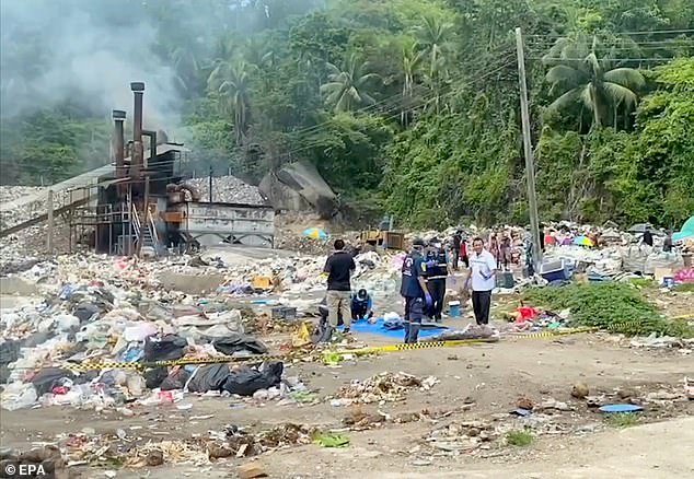 Police officers stand behind a cordon at a garbage dump where Mr Arrieta's body was found