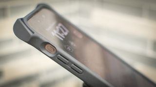 iPhone 15 Pro Max in a case, with the action button visible from the side