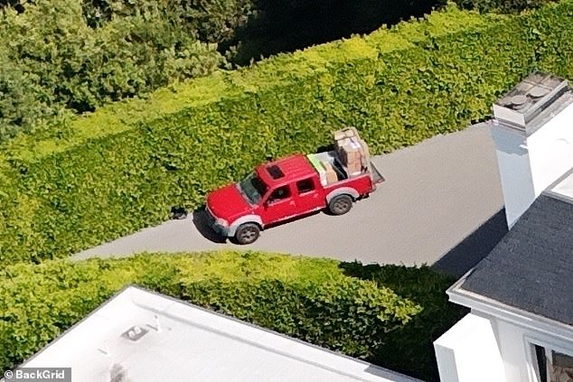 There was also a curious red pickup truck full of cardboard boxes parked outside the recently renovated home, which spans 46,000 square feet under roof and 38,000 square feet under air conditioning