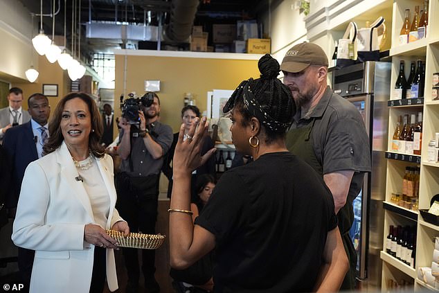 Kamala Harris listens during a stop at Dottie's Market in Savannah, Ga., as part of her bus tour