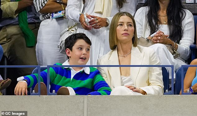 The actress, 42, who showed off her athletic skills in a workout video with her husband, 43, looked stunning in a cream-colored suit as she entered Arthur Ashe Stadium hand-in-hand with her 9-year-old son