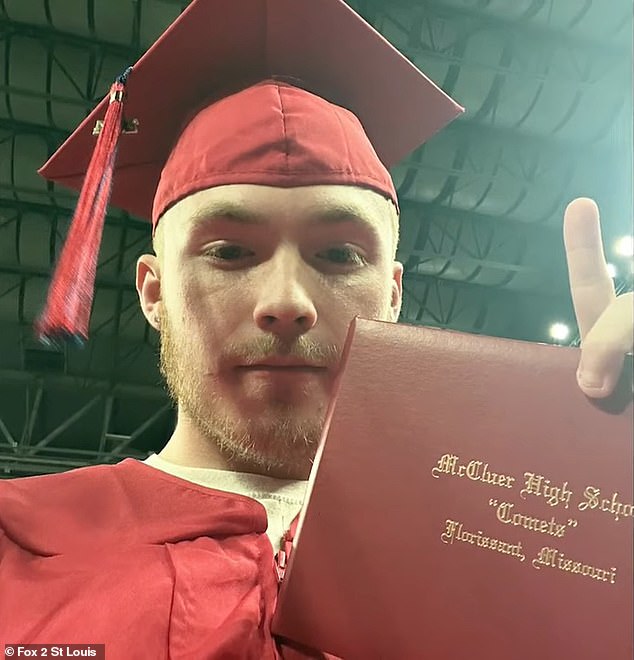 Proctor holds up McCluer High School diploma