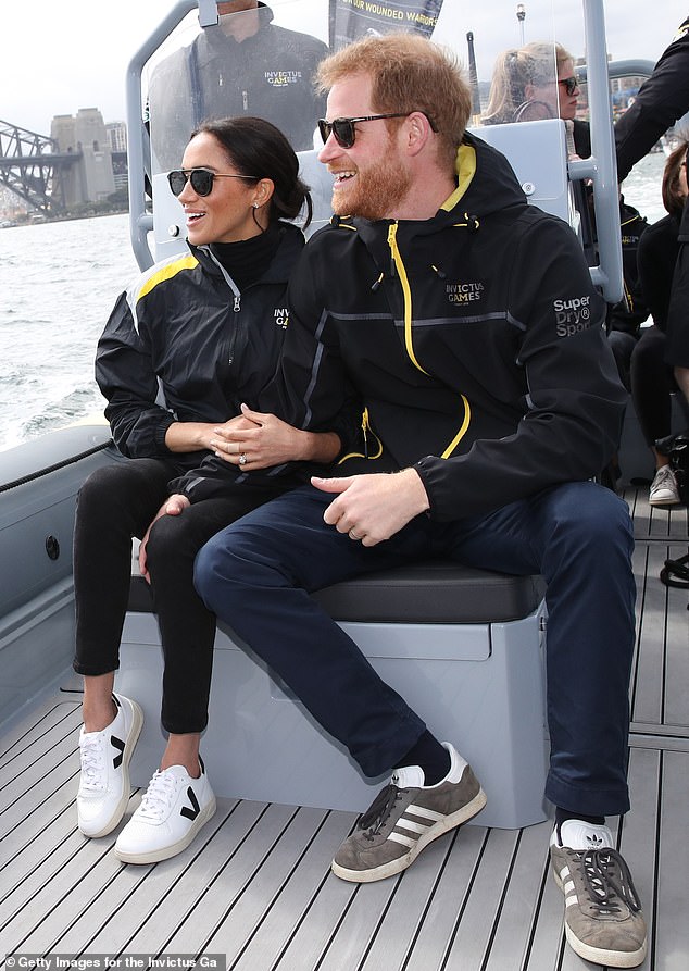 Meghan wears Veja's £120 white design, featuring a black V logo, to the 2018 Invictus Games