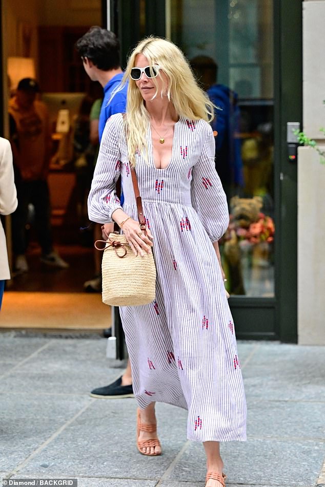 Claudia accessorized with a straw bag, white-framed sunglasses, and a pair of brown open-toe sandals