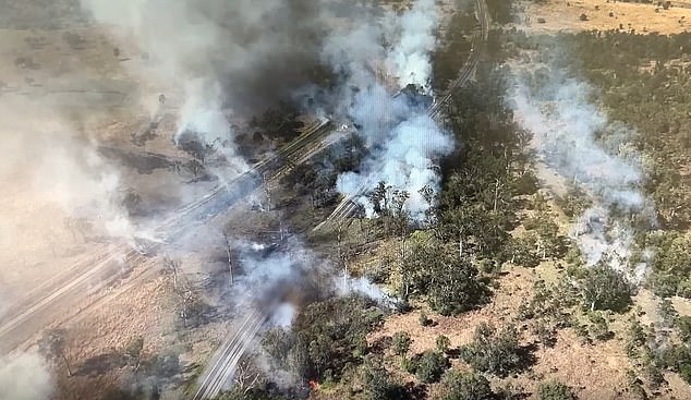 A shocking new view has revealed the extent of the damage (pictured) left behind after a massive chemical explosion caused by a pickup truck crashing into a truck on an extremely dangerous highway