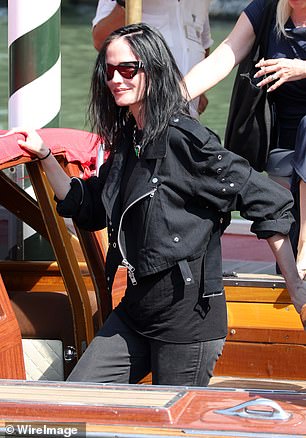 Eva wore a black biker jacket, black jeans and a simple black T-shirt and hid behind dark sunglasses