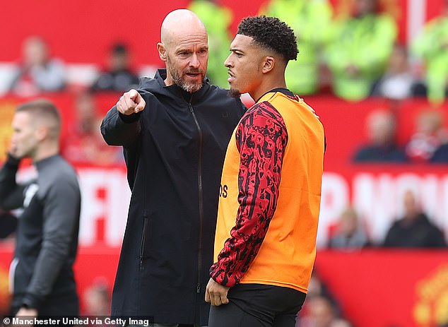 Manchester United manager Erik ten Hag pictured speaking to Sancho during a match in August 2023