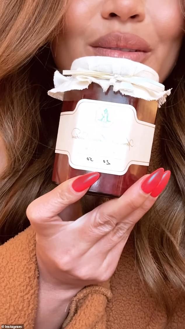 American model and TV personality Chrissy Teigen poses with a jar of Meghan Markle's jam