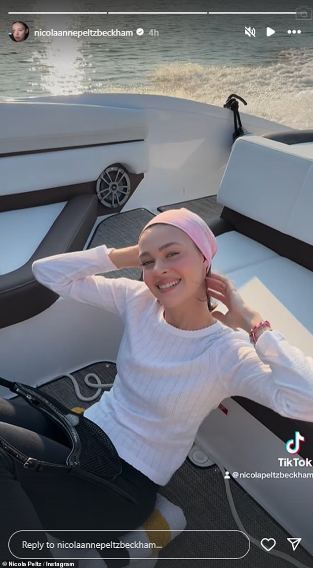 Nicola looked stylish as ever in a white top and jeans, wearing a bandana as she beamed for the camera