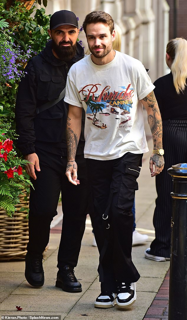 Shortly after, One Direction star Liam, 31, was spotted in a much more casual look, as he wore a casual white T-shirt, black cargo pants and a pair of black and white trainers