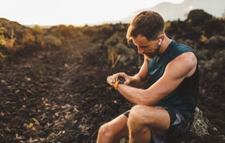 Runner with smartwatch and earphones