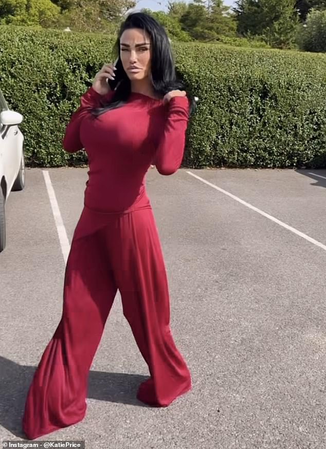 The glamour model looked stunning in a pair of floor-length dark red baggy trousers and a matching off-the-shoulder top