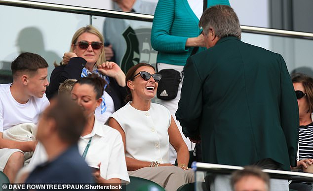 The beauty, whose husband Wayne, 38, is the manager of Plymouth Argyle, looked in high spirits as she enjoyed watching the match and chatting to others around her