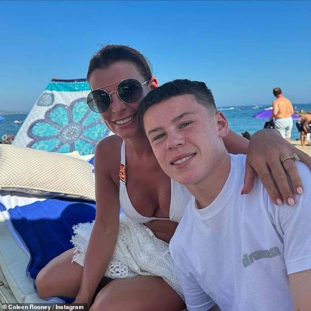 In one snap, Coleen slipped into a white bikini as she wrapped her arm around her eldest son Kai, 14, as they enjoyed a day at the beach