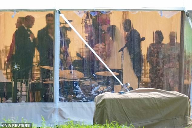 The bride and groom pictured during their wedding in the tent