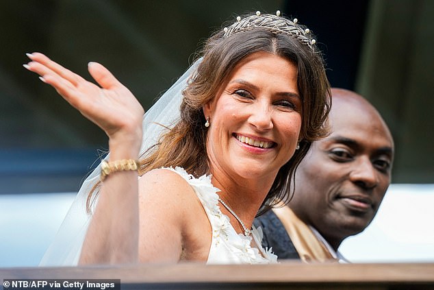 Princess Martha looks stunning in her tiara and veil as she waves to the crowd