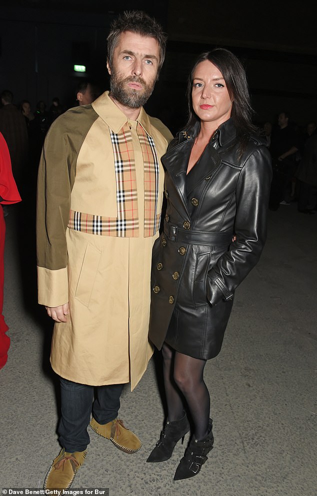 Liam Gallagher and his girlfriend Debbie Gwyther wear Burberry at the February 2018 show during London Fashion Week