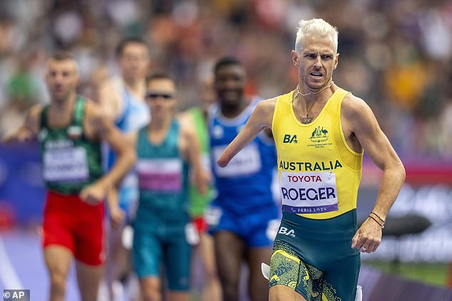 Australia's Michael Roeger (center) finishes second in the T46 1500m at Stade de France