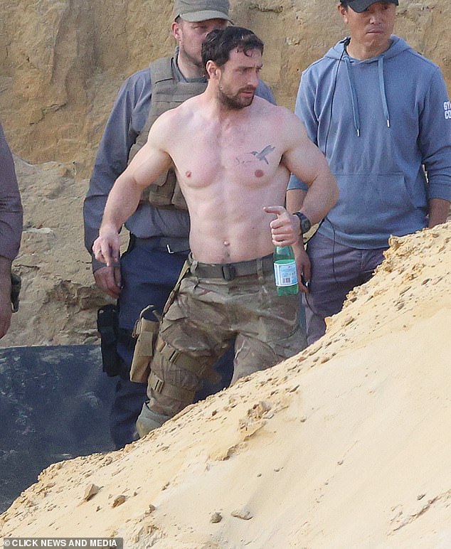 The actor is seen taking a sip of San Pellegrino sparkling water during filming of the thriller