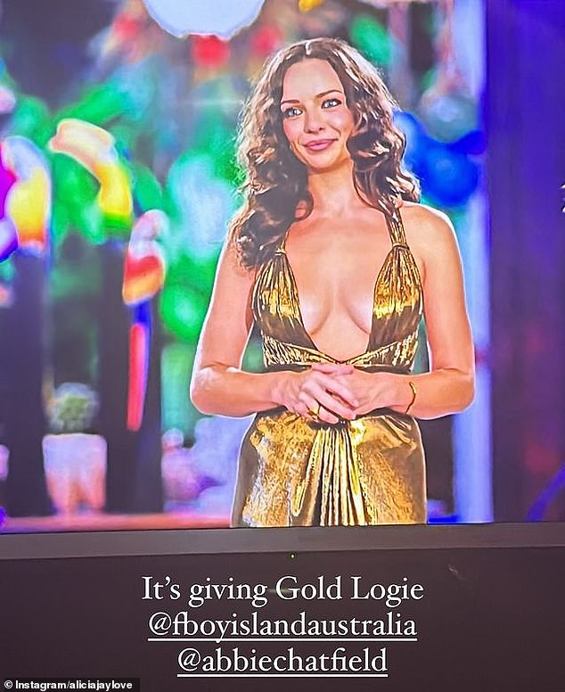 Abbie Chatfield (pictured) put the heat on Monday night's season two premiere of FBoy Island. The host opted for a plunging gold dress that showed off plenty of breasts and a little skin