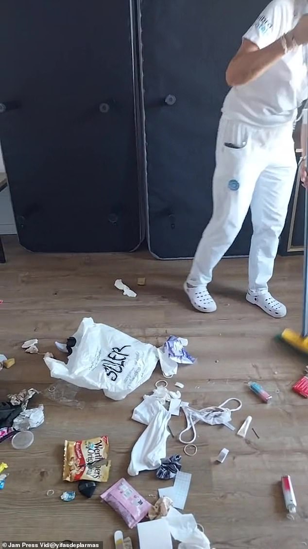 Headbands, underwear and discarded vapes can be seen among the trash as a cleaning company works