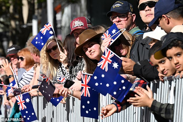 The proposal would add pokies rooms in casinos, pubs and clubs to the list of venues that would be closed on the day. Pictured are Aussies at this year's Anzac Day march in Sydney