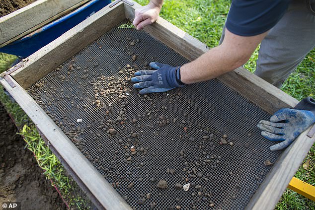 The excavation also revealed a pierced coin that was commonly worn by young African Americans as a good luck charm