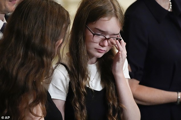 Miriam Butorin wipes away tears during the event at the White House