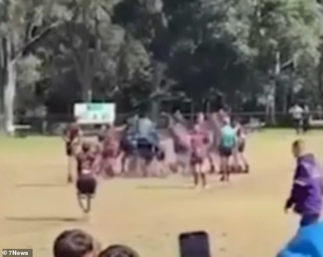 A wild brawl broke out during a junior rugby league match in Sydney, resulting in a man being thrown to the ground and kicked in the head.