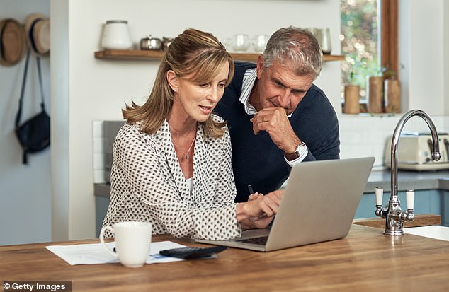 According to The Barefoot Investor, it was time to start saving for retirement after they spent $500,000 (before taxes) on their daughter's education (above, stock photo of a middle-aged couple looking at their finances)