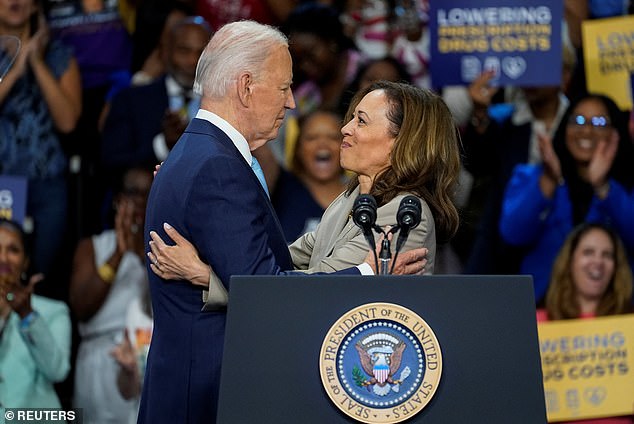 President Joe Biden and Vice President Kamala Harris embrace at an event in Maryland — their first public event since Biden left the presidential race