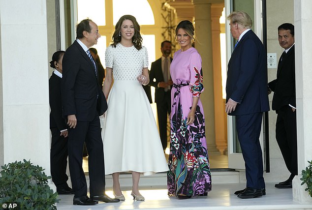 Pictured: Former President Donald Trump, right, stands with Melania Trump, second from right, as they are greeted by John Paulson, left, and Alina de Almeida, second from left, at a GOP fundraiser.