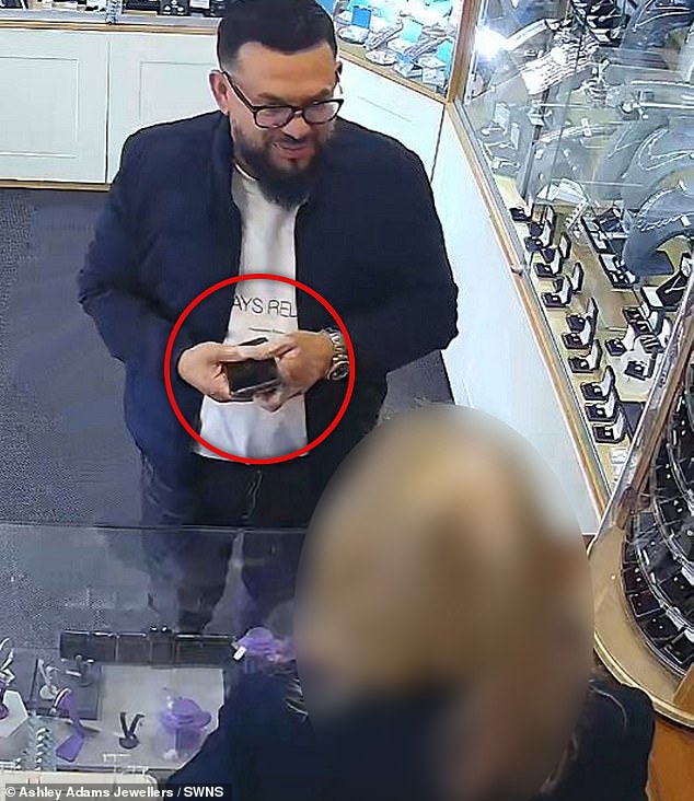 This comes after CCTV cameras in shops across the country exposed a 'gold swap scammer' (shown) who defrauded jewellers by swapping real and fake gold out of sight while they paid him