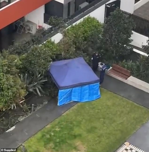 Police have set up a blue tent at the unit's complex after two bodies were found