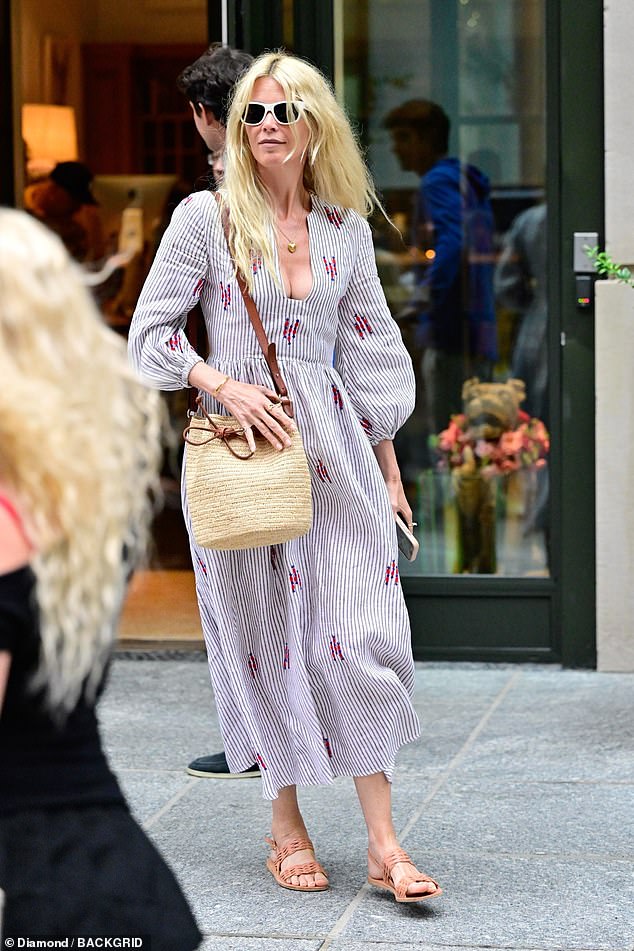 Claudia Schiffer enjoyed a family outing in New York City on Thursday. The 54-year-old German supermodel turned heads in a plunging summer dress that showed off her cleavage