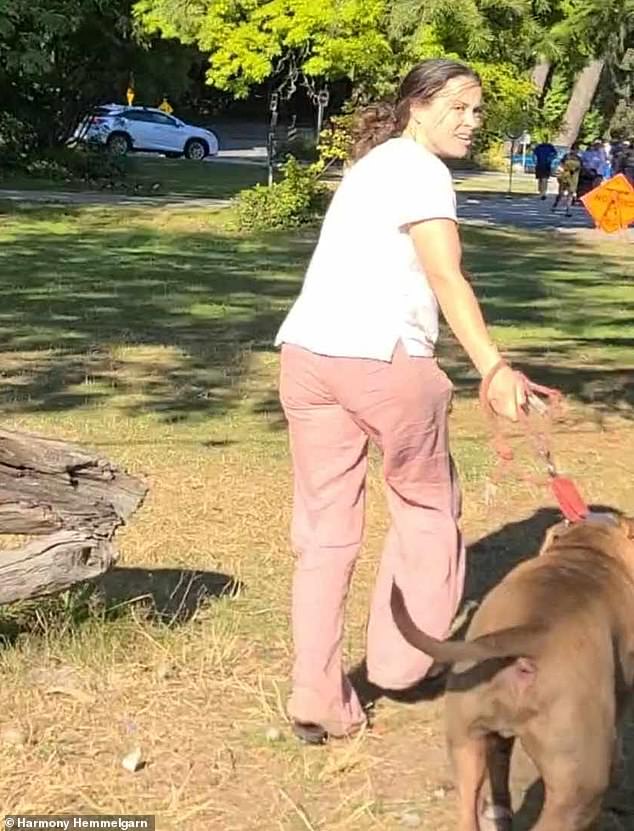 Footage captured a female dog owner being chased off a beach in British Columbia, Canada, on Monday after the dog bit another dog to death.