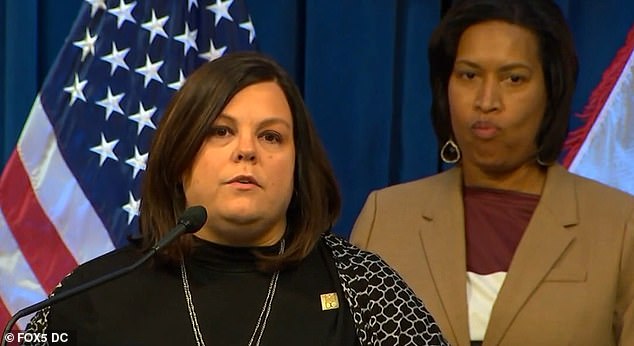 Dispatch Chief Heather McGaffin, seen here with Mayor Muriel Bowser, has offered her staff an extra $800 a month just for showing up to work when they're supposed to.