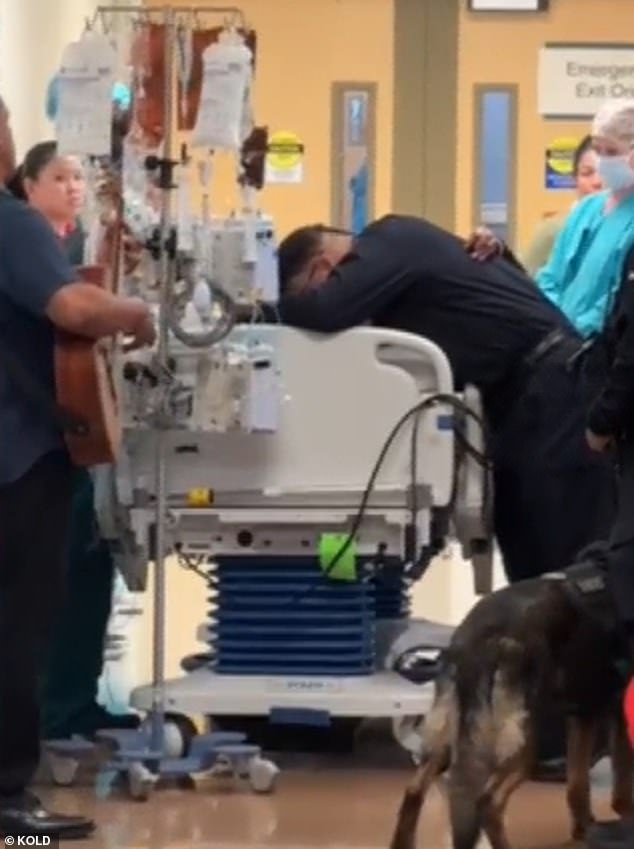 Robert Moreno cries over his daughter Zahriya's hospital bed before she was wheeled away for organ donation surgery after she was fatally injured during an argument with her boyfriend