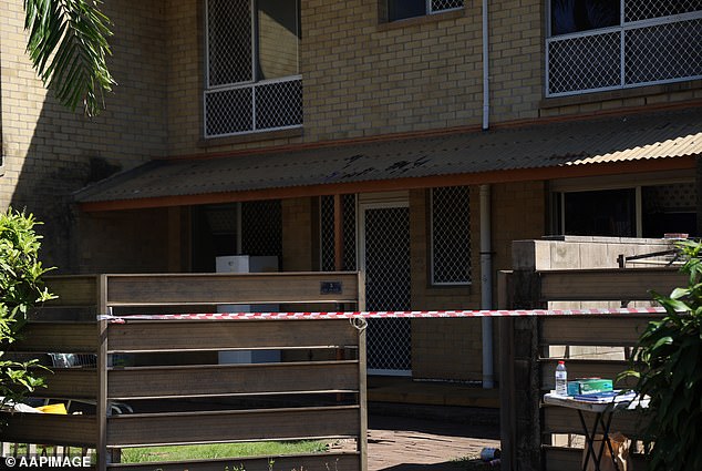 A woman has been murdered in a suspected case of domestic violence, with a man in custody (pictured is the Darwin home where the woman is believed to have died)