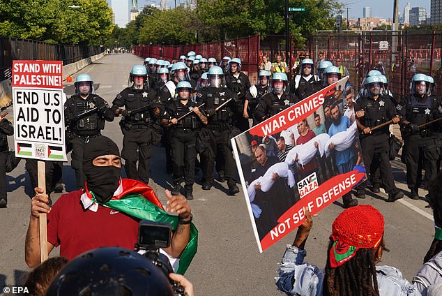 Police in riot gear prepare to hold back a group of protesters at the outer perimeter during a protest calling for a ceasefire in Gaza on the opening day of the Democratic National Convention (DNC) in Chicago