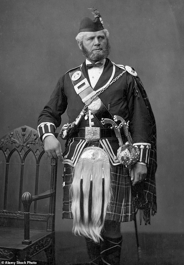 John Brown poses in a kilt, with ceremonial pistols on his hip