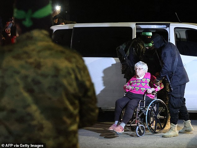 A recently released hostage is handed over to the Red Cross in Rafah here. She was one of about 250 who were taken