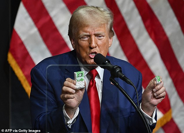 Donald Trump holds boxes of Tic-Tacs as he speaks at a campaign rally in North Carolina