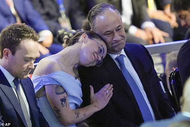 Second Gentleman Doug Emhoff is comforted by daughter Ella as he becomes emotional when his wife Kamala Harris takes the stage on the final night of the Democratic National Convention in Chicago, Illinois on Thursday