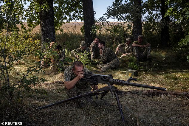 A soldier of the 22nd Mechanized Brigade of Ukraine aims a Browning M2 machine gun during a training exercise in the Sumy region, near the Russian border, during the Russian attack on Ukraine, August 17, 2024