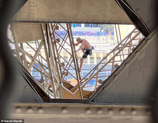 The shirtless man was spotted this afternoon climbing the 330-meter tower