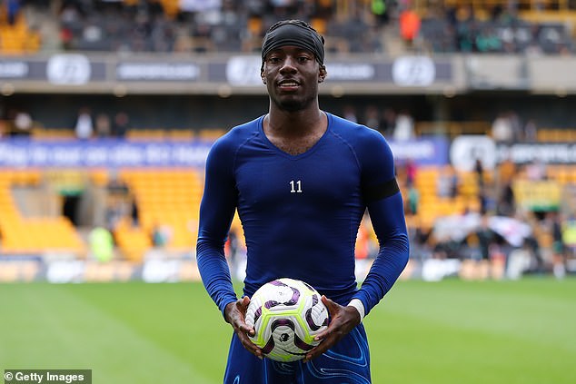 Noni Madueke poses with the match ball after his hat-trick for Chelsea at Wolves