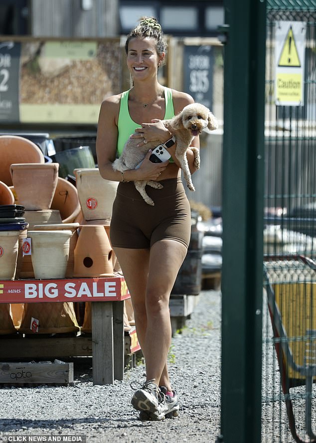 Ferne McCann, 34, couldn't keep the smile off her face as she stepped out in trendy sportswear in Essex on Wednesday, holding her adorable dog